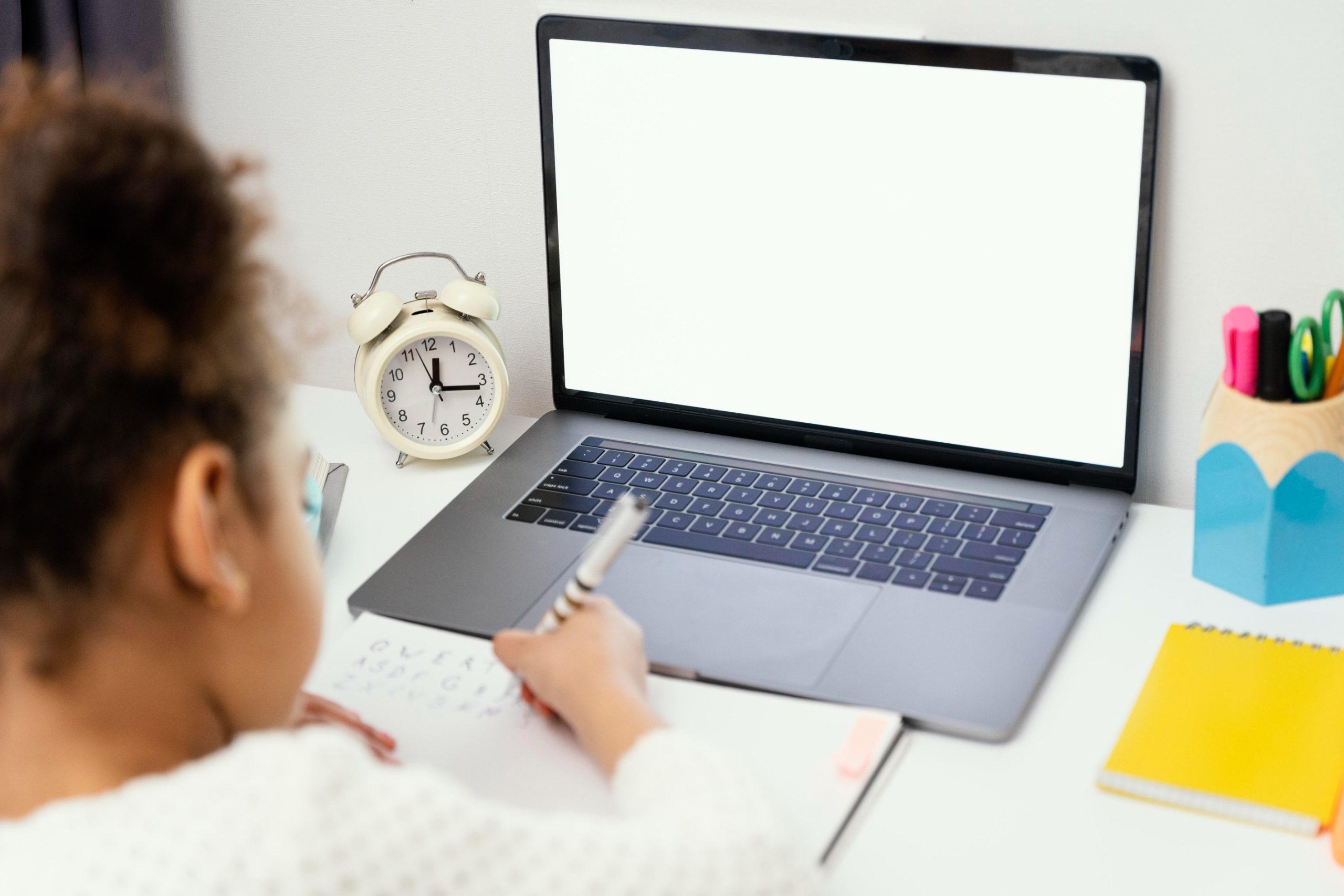 high-angle-little-girl-home-online-school-with-laptop (1)